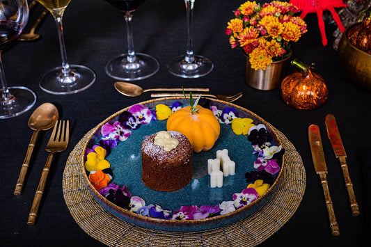 desert on a blue plate with flowers and golden cutlery